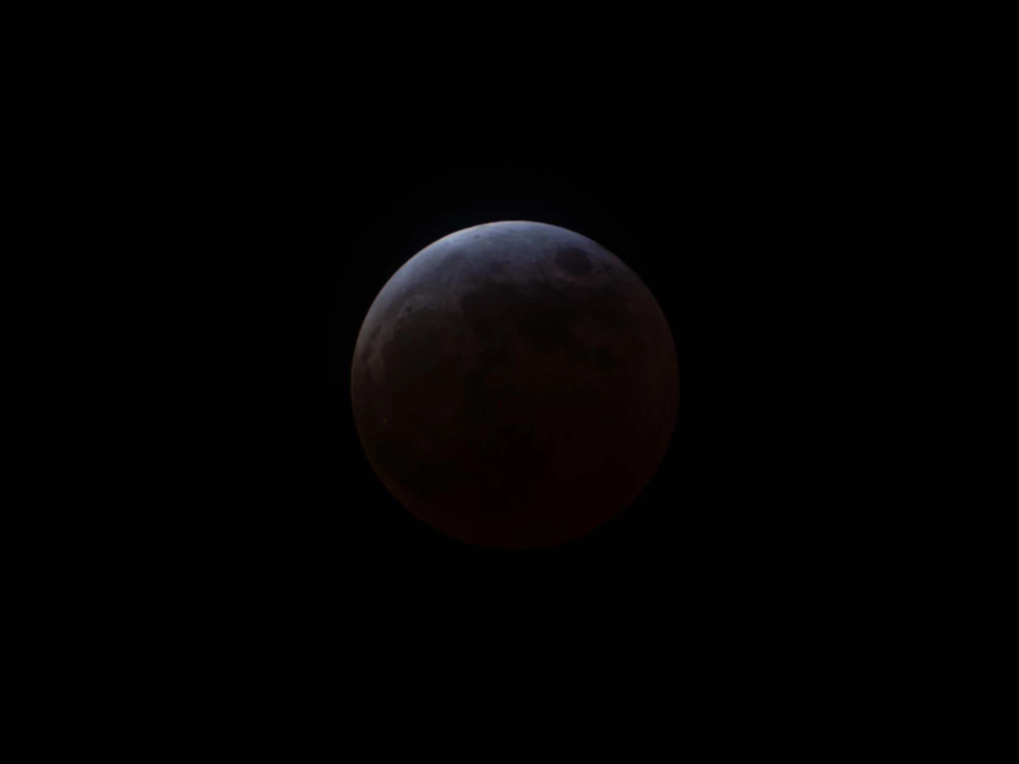 The moon had only a small bright section, and the rest started to turn dark red.